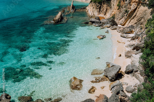 Hidden empty beach with pure clear turquoise sea water near white rock cliffs located in famous beach of Platys and Makrys gialos, Argostoli, Cefalonia island, Ionian, Greece photo