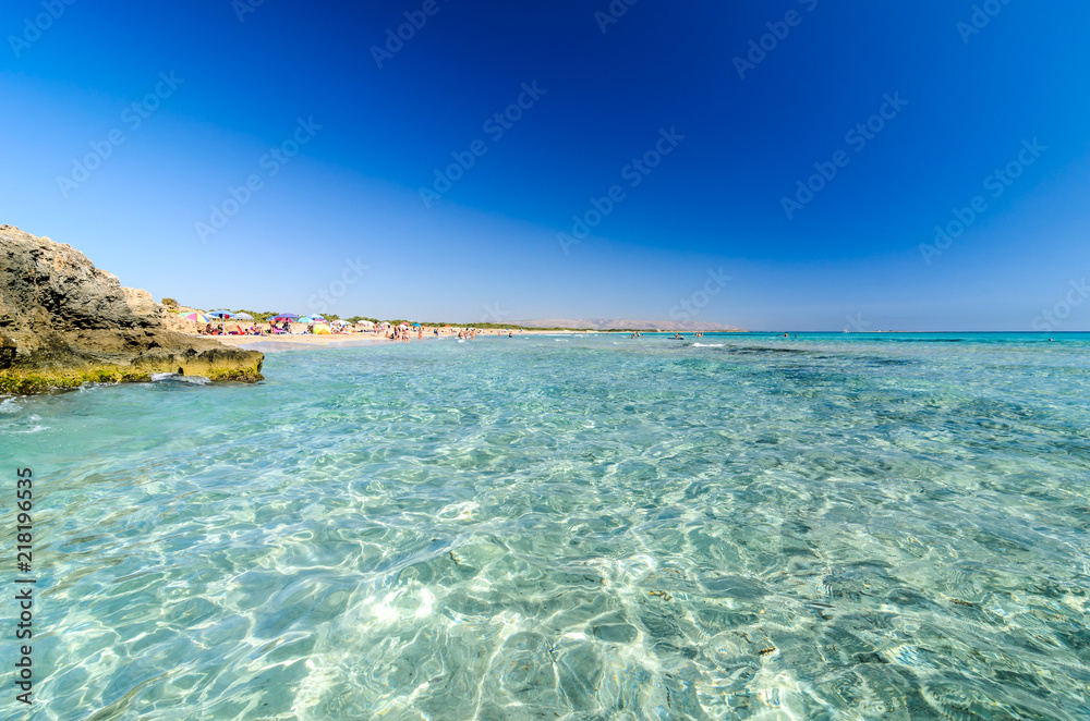 Obraz premium Beautiful crystal clear water at Cittadella dei Maccari, San Lorenzo, Nature Reserve Oasis of Vendicari, Syracuse, Sicily, Italy, Dreamy and idyllic spring holiday destination near Noto and Marzamemi.