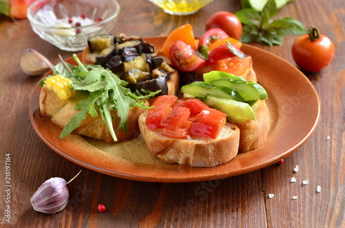 Various crostini with vegetables and herbs