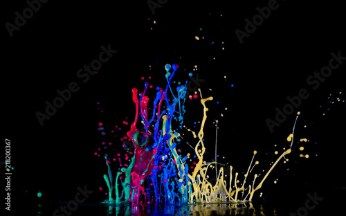 Abstract sculptures of colorful splashes of paint. Dancing liquid on a black background. Ink water splash. Color explosion.