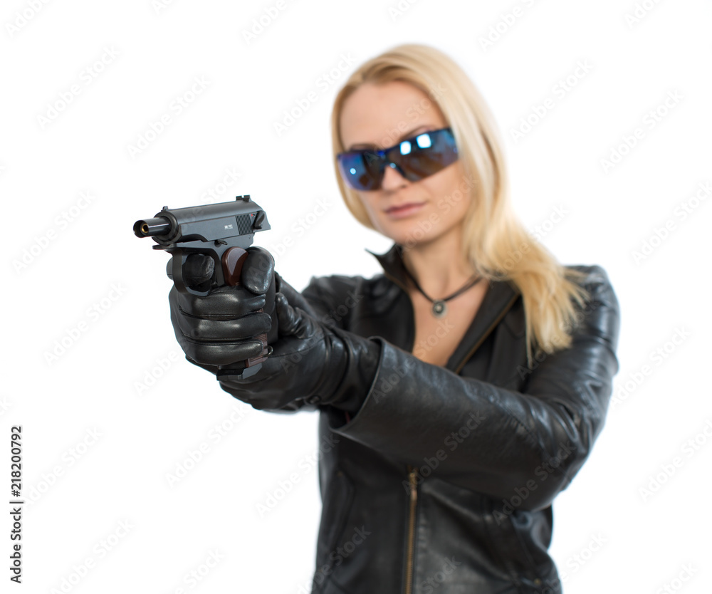 Young woman in sunglasses and a gun Young woman in sunglasses and a gun
