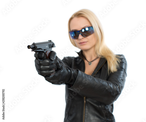 Young woman in sunglasses and a gun