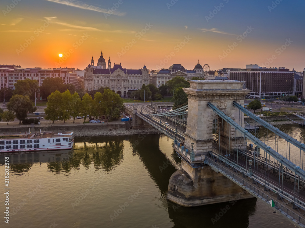 Budapest, Hungary - Aerial view of the Szechenyi Chain Bridge at sunrise with St. Stephen's Basilica at background