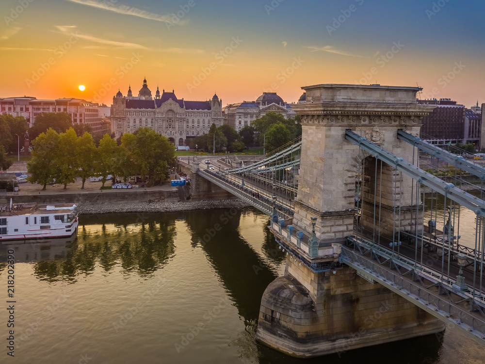 Budapest, Hungary - Aerial view of the Szechenyi Chain Bridge at sunrise with St. Stephen's Basilica at background