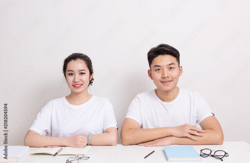 Young students studying together at table with books. Back to school Young students studying together at table with books. Back to school