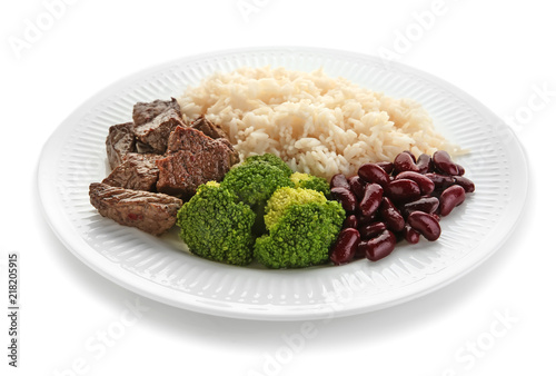 Tasty boiled rice with meat and vegetables on plate, isolated on white