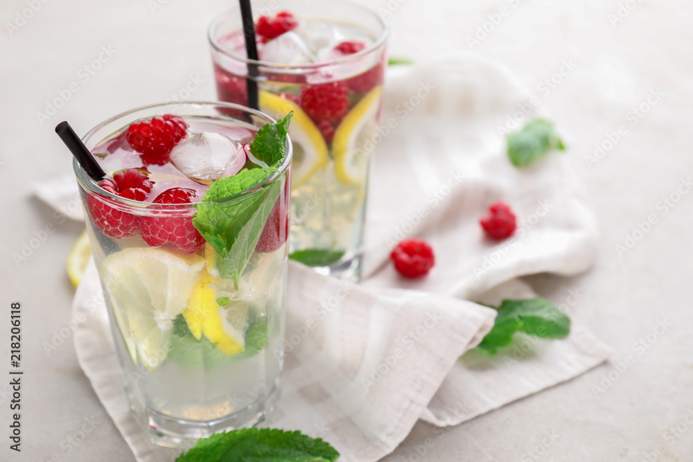 Glasses of fresh raspberry mojito on light table Glasses of fresh raspberry mojito on light table