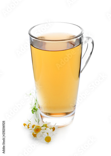 Glass cup of delicious camomile tea on white background