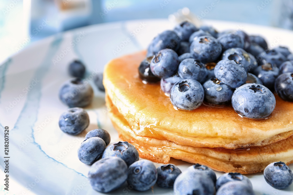 Tasty pancakes with blueberries on plate, closeup Tasty pancakes with blueberries on plate, closeup
