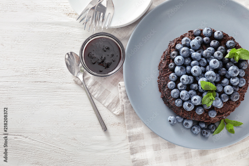 Delicious blueberry chocolate cake on white table Delicious blueberry chocolate cake on white table