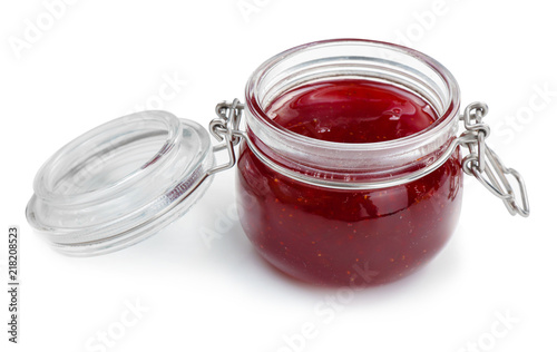 Glass jar with delicious strawberry jam on white background