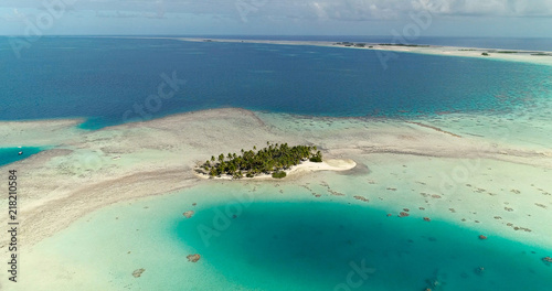small islands (motu) in the middle of a lagoon in aerial view, French Polynesia