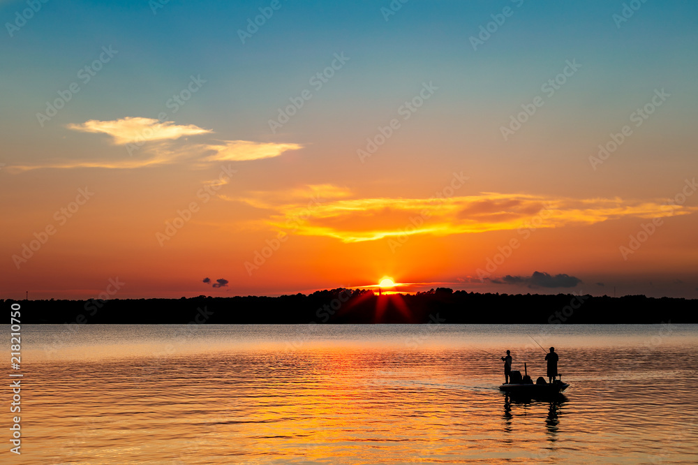 Fishing on a lake at sunset.