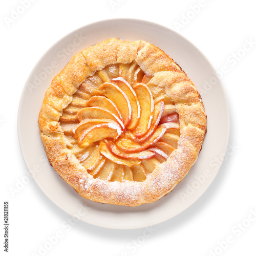 Plate with delicious peach galette on white background