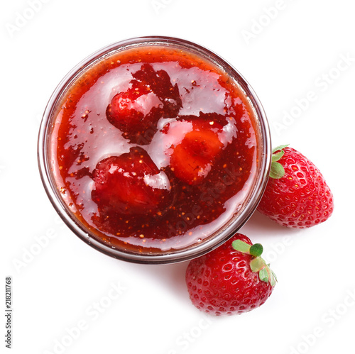 Bowl with delicious strawberry jam on white background photo