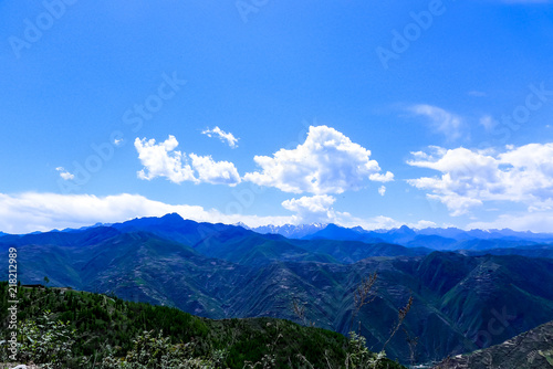 Green and High Mountains under the Blue Sky