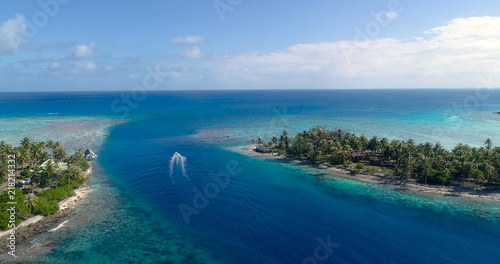 small island in a lagoon with a motor boat © Fly_and_Dive