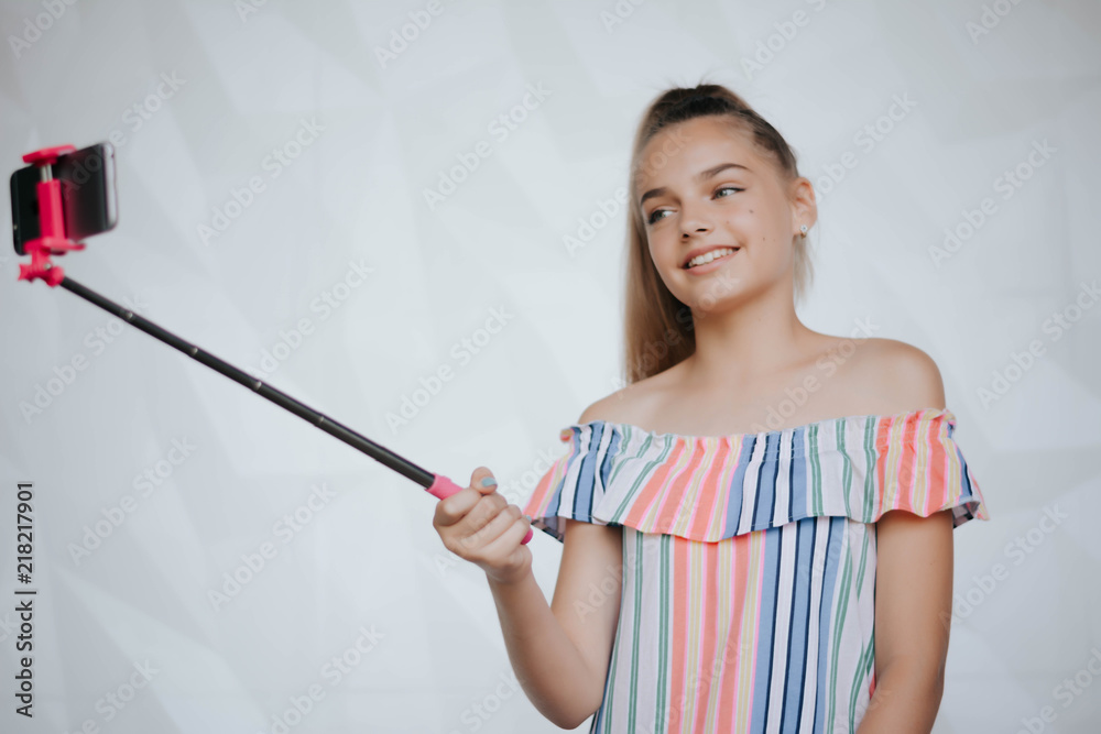Beautiful young girl is making selfie photo with smartphone. Young hipster woman making selfie. Photo.Smartphone Beautiful young girl is making selfie photo with smartphone. Young hipster woman making selfie. Photo.Smartphone