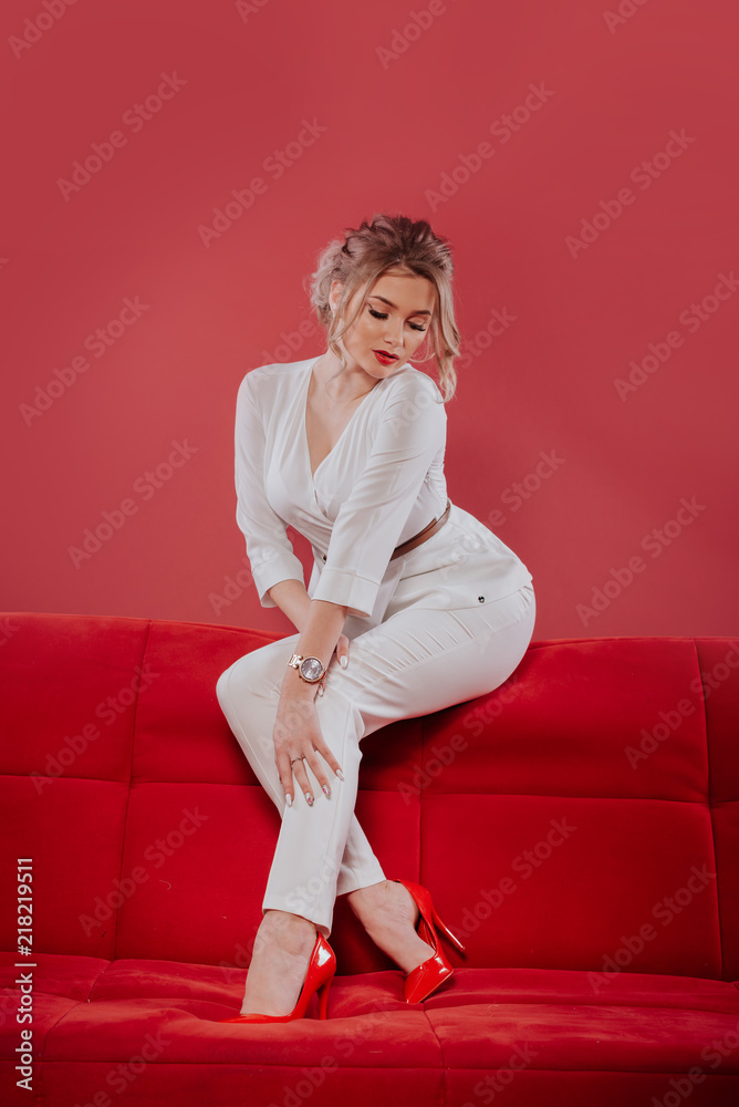 The girl in a red dress. Lady in red. Stylish interior. Velvet dress. Curly  hair. Red lipstick Glamorous lady business. Sexual Breasts. Stock Photo |  Adobe Stock