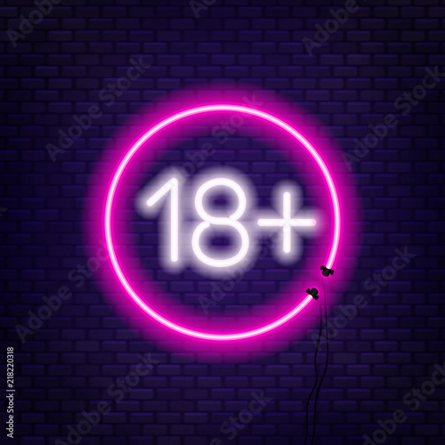 Eighteen plus neon sign on brick wall background.
