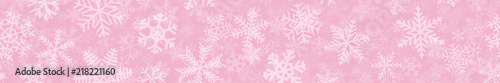 Christmas horizontal seamless banner of many layers of snowflakes of different shapes, sizes and transparency. White on pink.