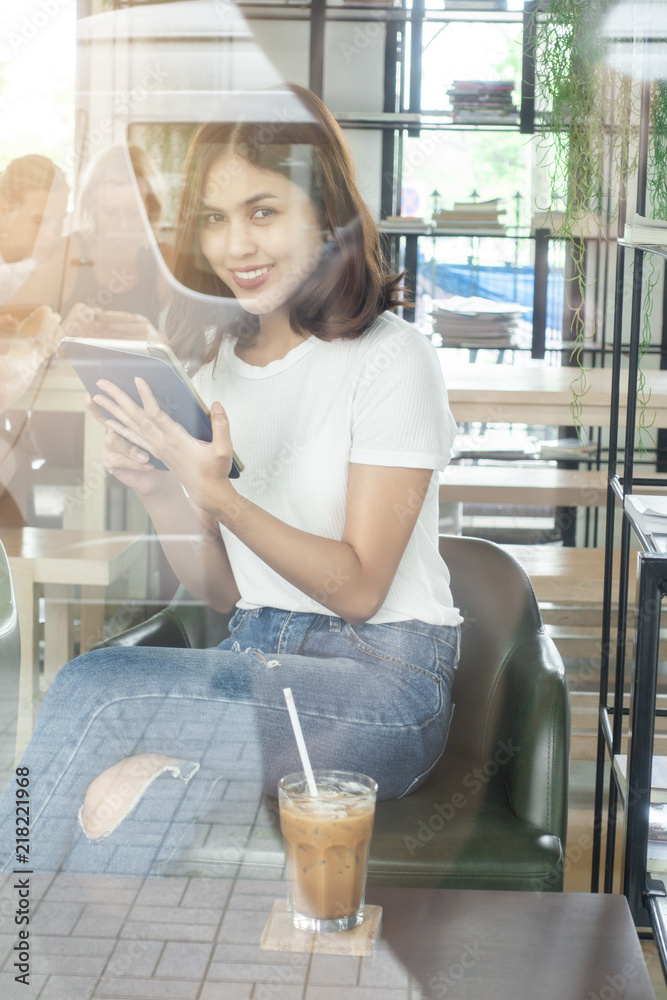 Beautiful business girl working with tablet , smartphone and drinking coffee in coffee shop Beautiful business girl working with tablet , smartphone and drinking coffee in coffee shop