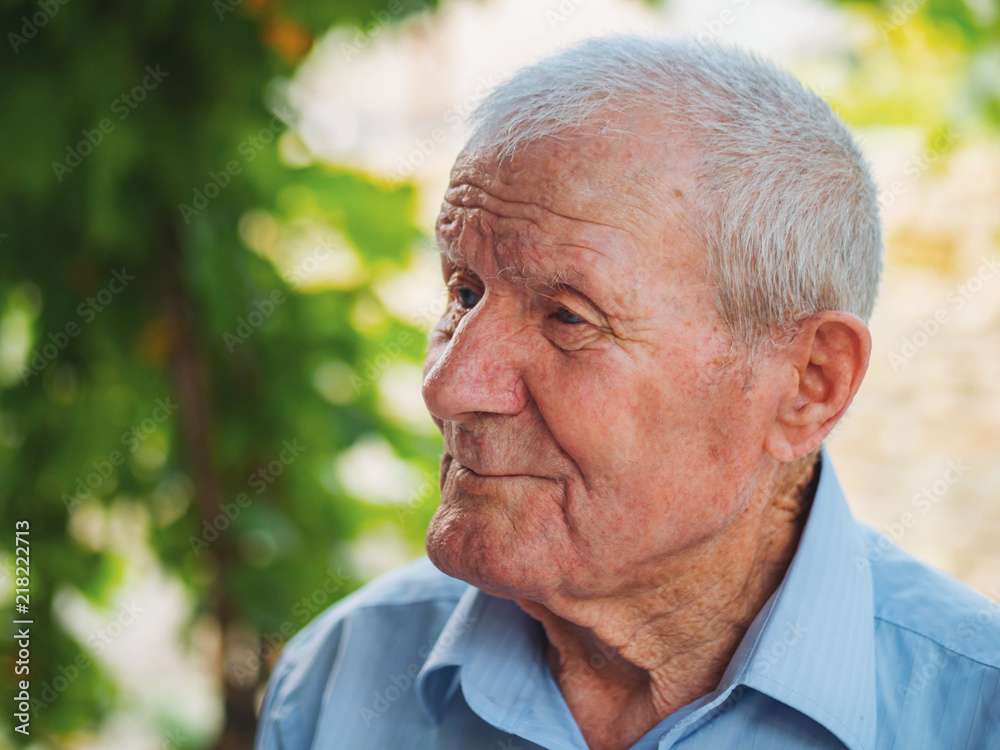 Very old man portrait. Grandfather relaxing outdoor at summer. Portrait: aged, elderly, senior. Close-up of old man sitting alone Very old man portrait. Grandfather relaxing outdoor at summer. Portrait: aged, elderly, senior. Close-up of old man sitting alone