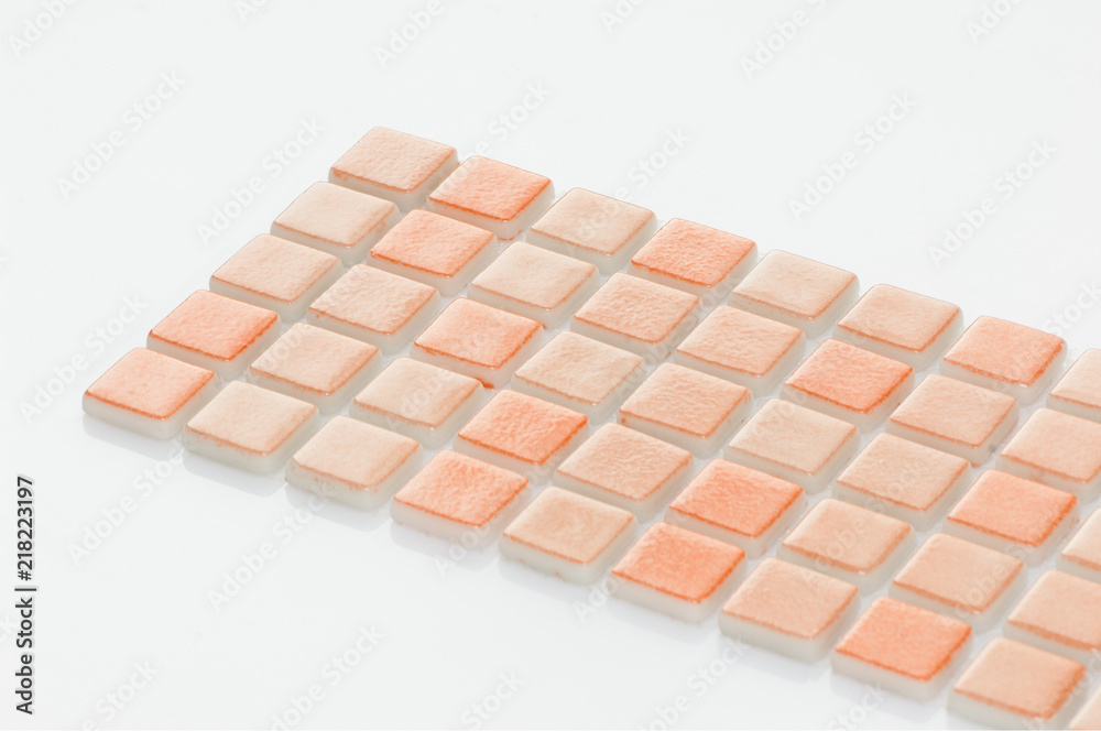 Fototapeta premium little orange ceramic tile on a white background, majolica. for the catalog
