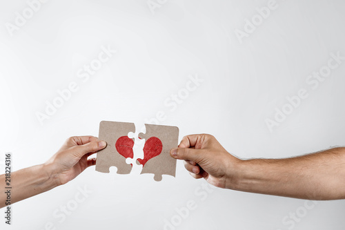 Parts of the puzzle form the heart, broken. The concept of divorce, quarrel, conflict. photo