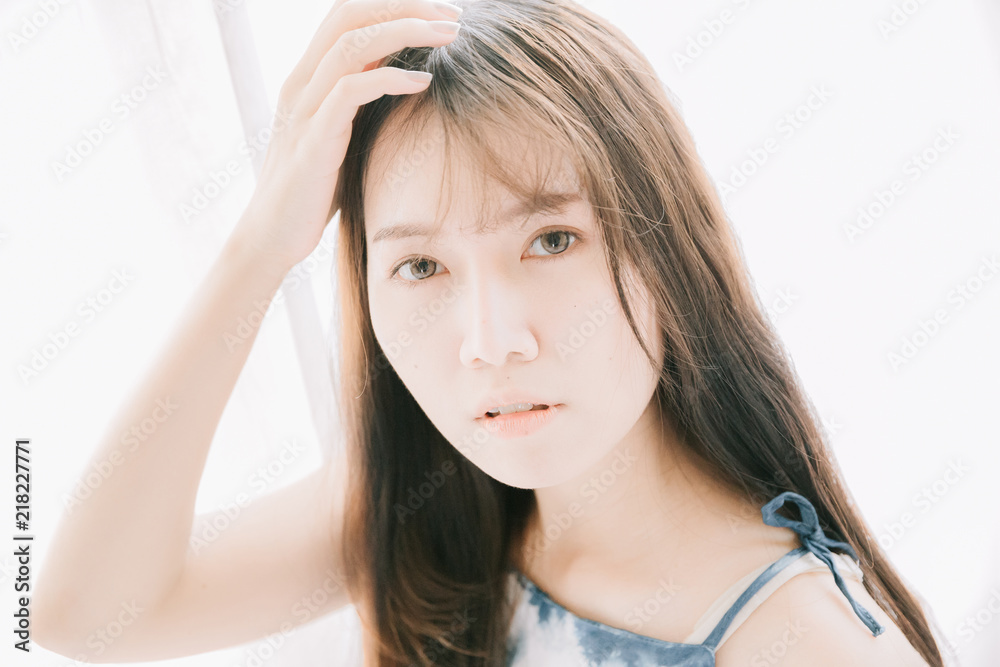 Fototapeta premium Portrait beautiful asian girl looking in white room film vintage style