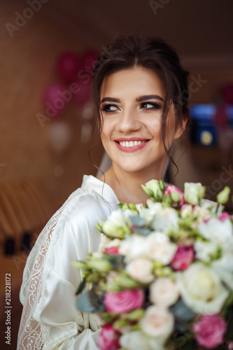Beautiful bride with fashion wedding hairstyle - on white background Wedding. Studio shoot.Beautiful bride with bouquet of flowers