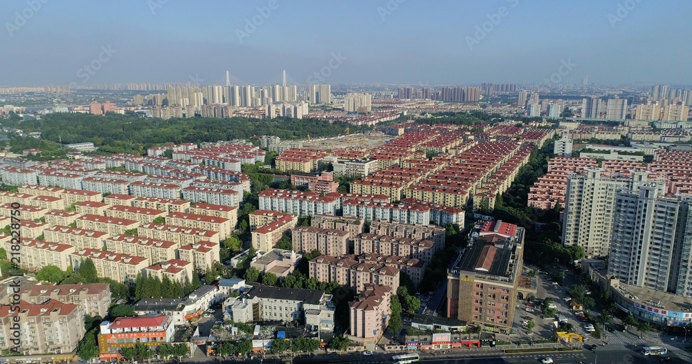 Aerial view on highly populated residential area with blocks of skyscrapers and residential buildings. Shanghai, China.