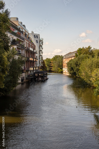 Picture from the river elster in leipzig .It is a popular place of residens in modern architectur in old and new buildings  .This is a beautiful place for watersports. photo