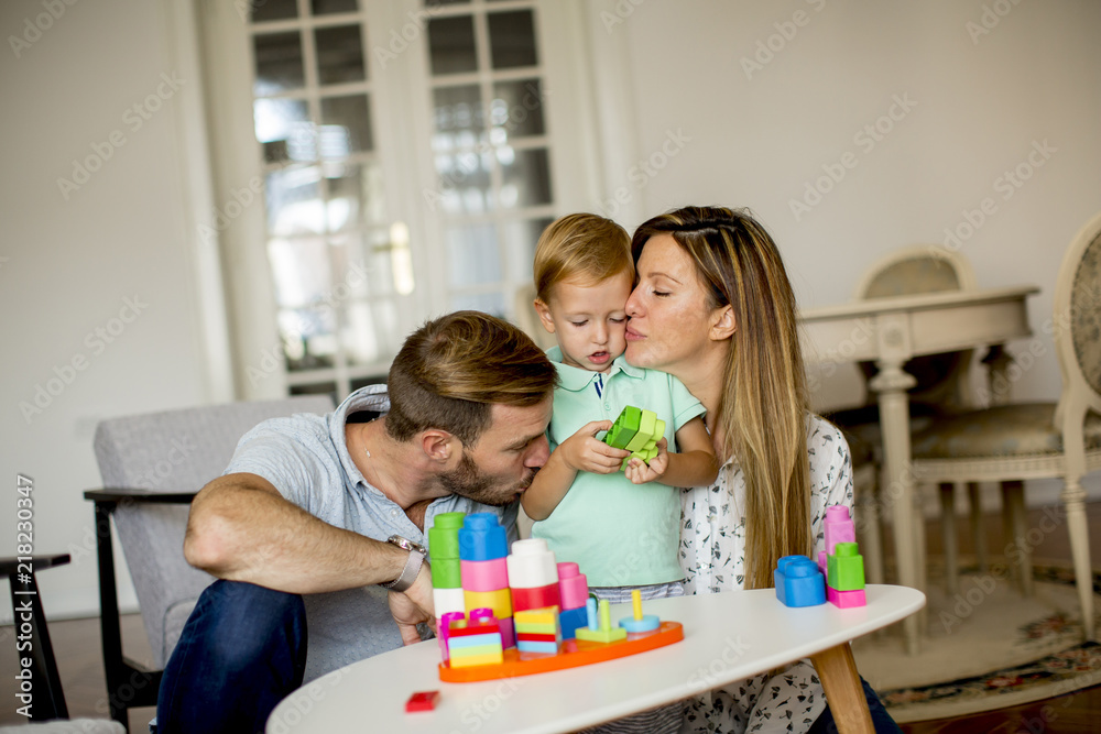 Little boy playing toys with mother and father at home Little boy playing toys with mother and father at home
