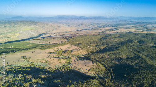 An aerial view of Chile countryside from the drone, hills, valleys and a rugged landscape from the near distance to an infinite horizon