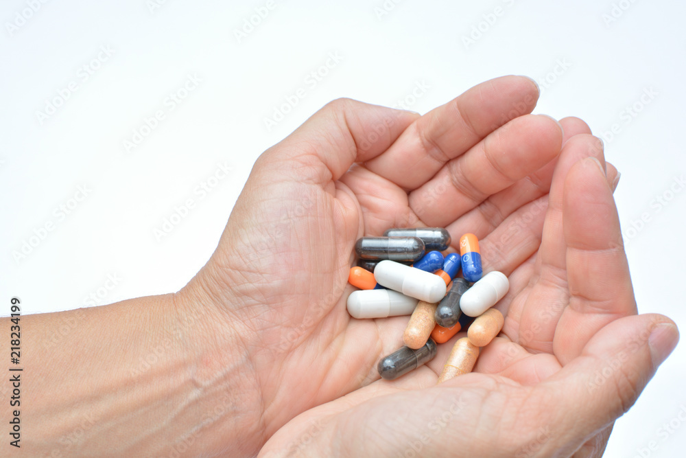 Manos mostrando un cóctel de diferentes medicamentos para el tratamiento de enfermedades como el VIH o simplemente como complementos alimenticios o adelgazamiento Manos mostrando un cóctel de diferentes medicamentos para el tratamiento de enfermedades como el VIH o simplemente como complementos alimenticios o adelgazamiento