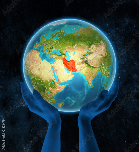 Iran on Earth in hands in space
