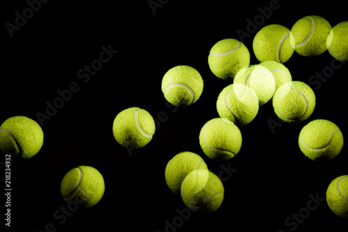 Fotografía Movement or bounce of tennis ball isolated on black background.