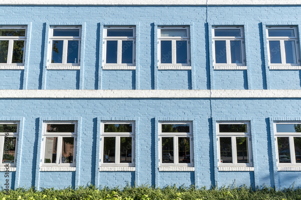 Fototapeta premium Blue brick house with white windows