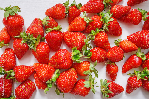 Fresh strawberry. Strawberries on white concrete background. Harvest of organic local strawberries