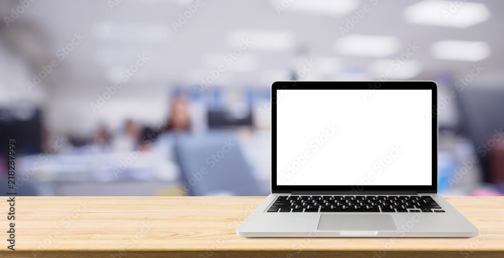 Laptop with blank screen on desk table with blur office interior background Laptop with blank screen on desk table with blur office interior background