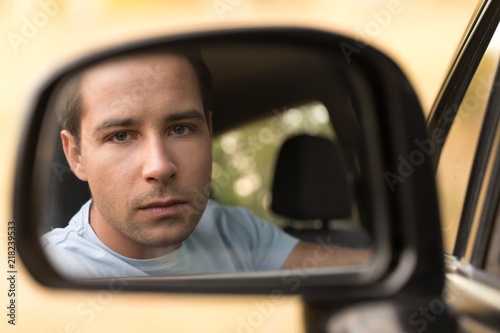 Portrait of a Man Driving a Car in Side View Mirror © BillionPhotos.com