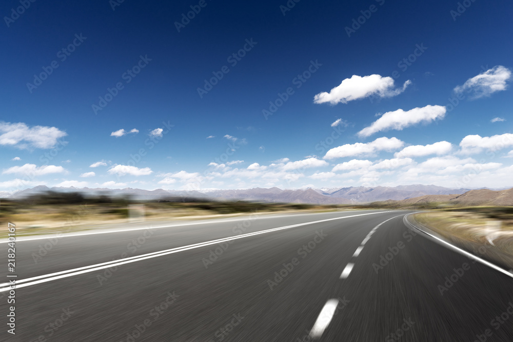 Fototapeta premium highway through mountain with blue sky