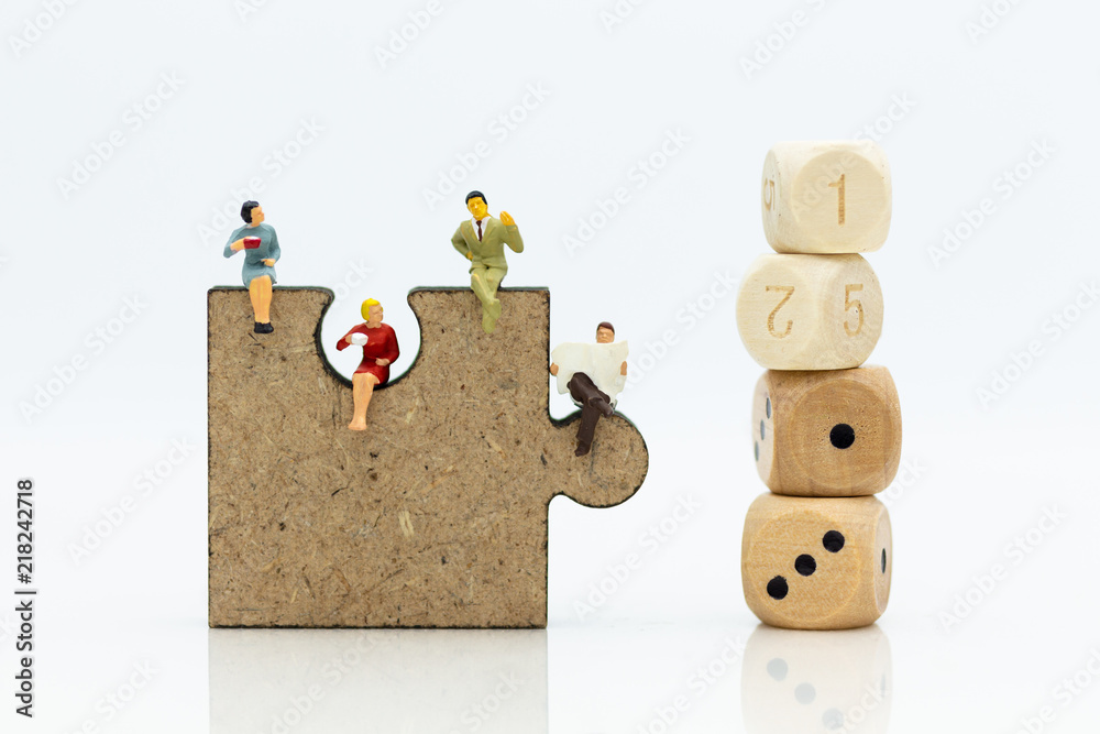 Fototapeta premium Miniature people : businessman sitting on jigsaw puzzle pieces . Image use for solve, finding solution, business vision concept.