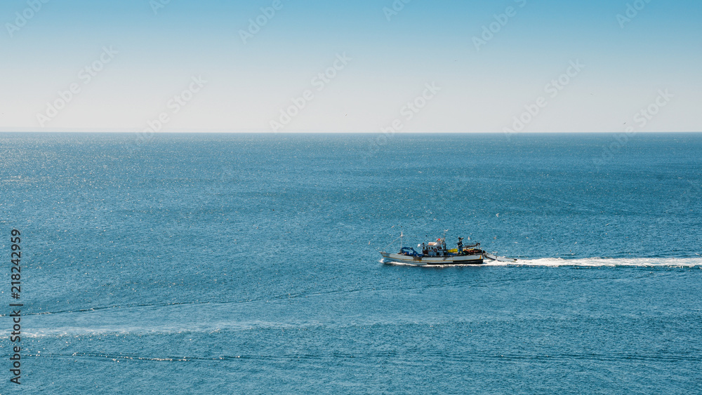 Naklejka premium Fishing boat returning to home harbor, Portugal