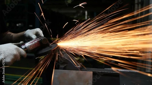 Electric wheel grinding on steel structure in factory. photo