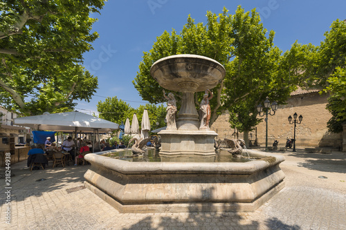 Village square with fountain and restaurant of Maussane les Alpilles. Buches du Rhone, Provence, France