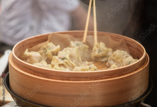 Steamed Korean dumplings Mandu with chicken meat and vegetables in a bamboo steamer