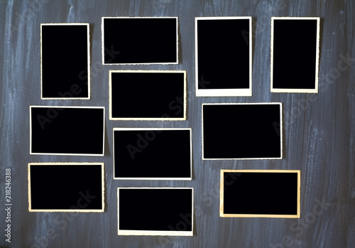 old empty photo frames, vintage photo prints on grungy background with free space for pictures