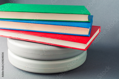 Multicolored books lie on gray pancakes from a sports bar